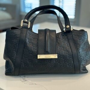 Authentic Gucci Medium Handbag. Black leather with gold accents.
